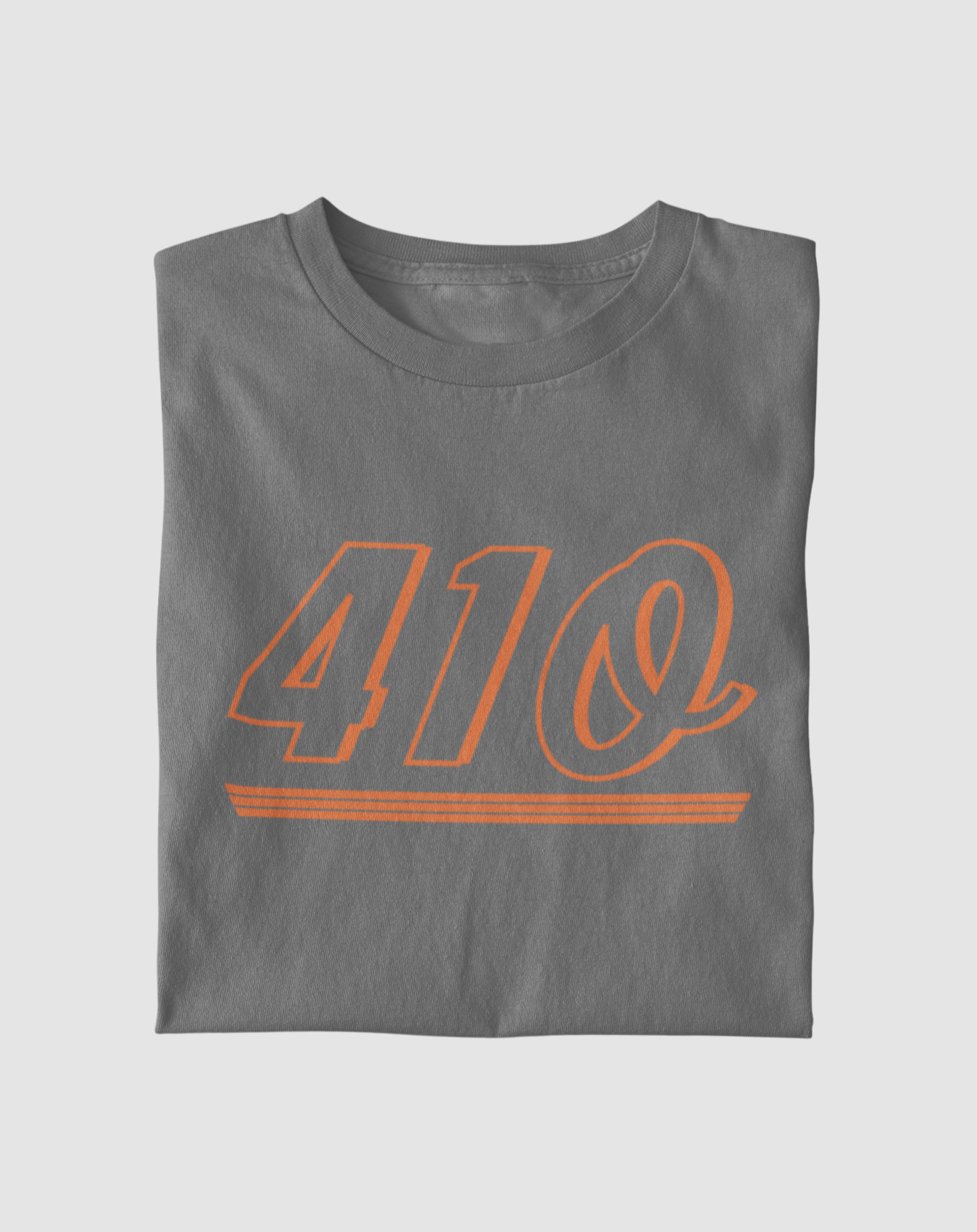 This is a folded T-shirt that is dark grey. This shirt has a design on it that is orange in color. The design says 410, which is an ode to the area code of Baltimore. The design on the shirt is about 10 inches wide, and about 6 inches long. 