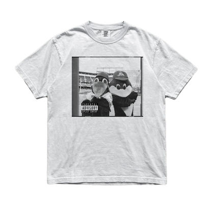 A light gray heather crewneck t-shirt featuring a black and white graphic print of two penguin mascots posing together with a 'Parental Advisory' label overlay, displayed flat against a white background.