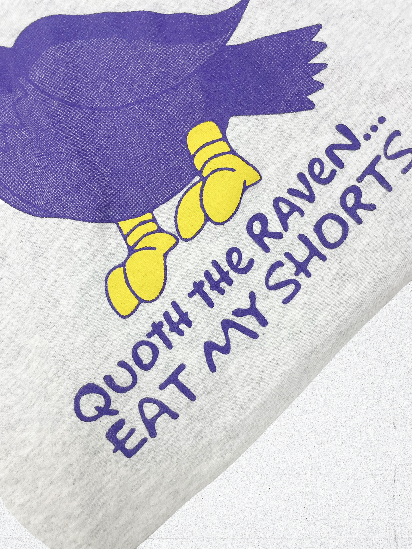 A close up of the Bart The Raven T-Shirt. This picture shows a closeup of the shirt with text on the shirt that says "Quoth the Raven Eat My Shorts"